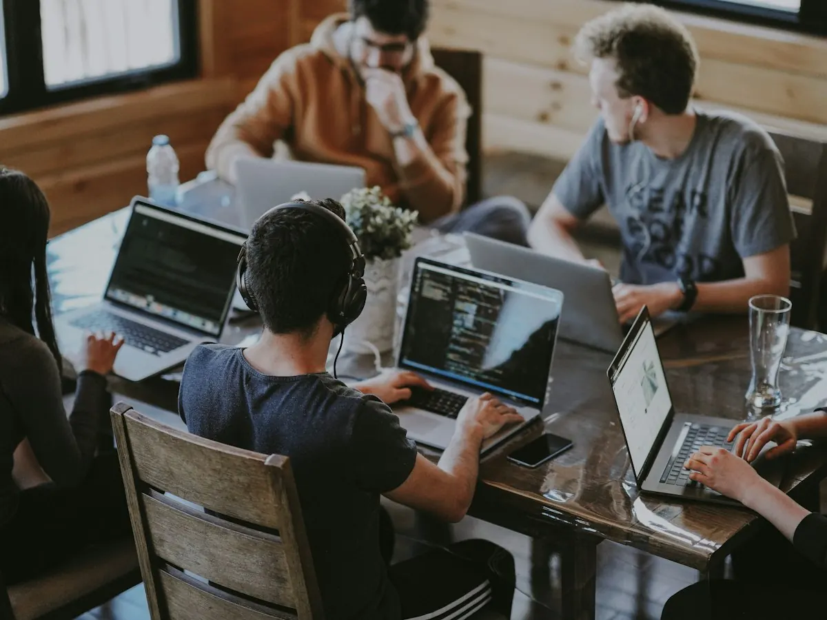 A team working on laptops around a table