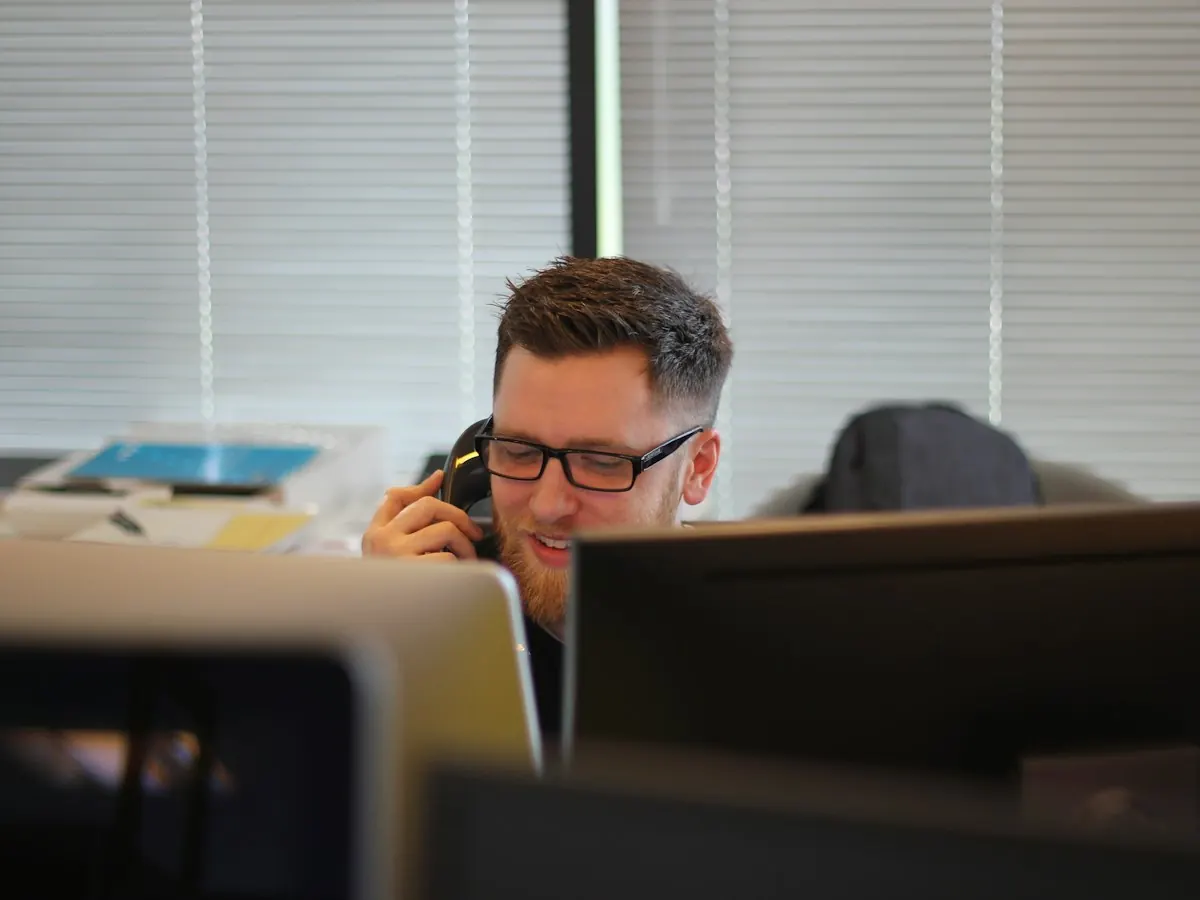 A man on the phone at his desk in an office